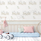 Children's room with a crib, toy car, and decorative wallpaper with elephant pattern.