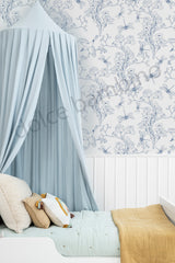 Bedroom with floral wallpaper, canopy bed, and decorative pillows.