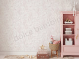 Pink children's room with a floral wallpaper,bookshelf,toys,and decorative items.