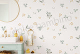 A wall adorned with a floral and leaf pattern wallpaper.