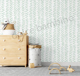 Children's room with chevron-patterned wallpaper, wooden dresser, and toys.