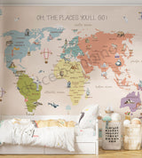 A multicolored world map wall mural in a children's room, with the phrase 'OH, THE PLACES YOU'LL GO' at the top.