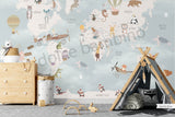 Children's room featuring a colorful world map wallpaper with illustrations of animals and vehicles. A wooden dresser and a canvas storage basket are visible in the room.