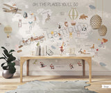 Children's room featuring a colorful world map wallpaper with illustrations of animals and vehicles. A wooden dresser and a canvas storage basket are visible in the room.