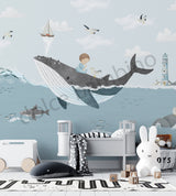Children's room with whale wall mural, toys, and furniture.