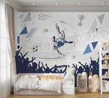 Children's room with soccer-themed wall mural and bedding.