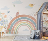 Children's room with a rainbow and floral wall mural, soft lighting, and decorative elements.
