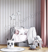 Kids bedroom with blue striped wallpaper, soft grey bedding, and modern nursery furniture