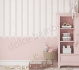 Children's room with pink striped pattern scalloped wallpaper, bookshelf, and toys.