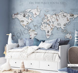 A wall mural featuring a watercolor animal world map with various continents, oceans, and wildlife illustrations, displayed in a room setting with furniture.