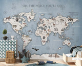 A wall mural featuring a watercolor animal world map with various continents, oceans, and wildlife illustrations, displayed in a room setting with furniture.