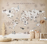 A wall mural featuring a watercolor animal world map with various continents, oceans, and wildlife illustrations, displayed in a room setting with furniture.