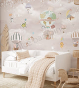 A wall mural featuring whimsical animal characters in a sky with hot air balloons, presented in a room setting with a white bed.