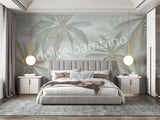 A section of wallpaper with a design of coconut trees and palm leaves in various shades of green, displayed in a room setting.