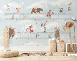 A wall mural featuring various cartoon animals playing musical instruments, with a musical staff background.