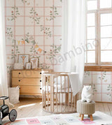 Nursery room with floral wallpaper, wooden furniture, and toys.