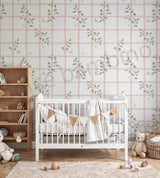 Nursery room with white crib, floral wallpaper, and wooden bookshelf.