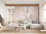 A section of wallpaper with a floral pattern featuring banana leaves in pink and green shades, and coconut tree leaves in the background, applied on a wall in a living room setting.
