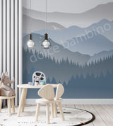 Children's room with mountain mural, table, chairs, and toys.