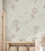 Wallpaper with hot air balloons and clouds pattern in a room with a wooden bench and baskets.