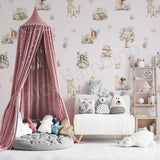 Children's room with fairy themed wallpaper, pink canopy, white sofa, and decorative pillows.