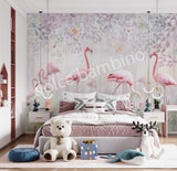 A bedroom wall mural featuring a group of flamingos in a garden setting with greenery and a white bear-like figure, likely a teddy bear, on a bed.