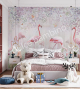 A bedroom wall mural featuring a group of flamingos in a garden setting with greenery and a white bear-like figure, likely a teddy bear, on a bed.