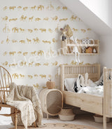 Children's room with beige wallpaper featuring a repeating pattern of safari animals like lions, zebras, and elephants in gold tones.