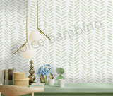 Room interior with a chevron patterned wall, table with decor items.