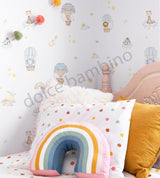 A wall adorned with colorful, playful wallpaper featuring various whimsical characters and a rainbow-colored balloon. 