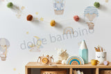 A wall adorned with colorful, playful wallpaper featuring various whimsical characters and a rainbow-colored balloon. 