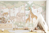 Hand-illustrated safari wallpaper with giraffes, elephants and monkeys in a kids’ room

