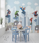 Superhero mural on a wall with a children's table and chairs in the foreground.
