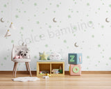 Children's room with toys and a chair against a moons and stars wallpaper.