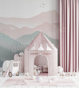 Children's playroom with a pink play tent, toys, and a mountain mural on the wall.