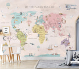 A pantone world map wall mural in a children's room, with the phrase 'OH, THE PLACES YOU'LL GO' at the top.