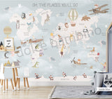 Children's room featuring a colorful world map wallpaper with illustrations of animals and vehicles. A wooden dresser and a canvas storage basket are visible in the room.