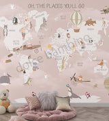 Children's room with Nordic Fun World Map mural featuring illustrations of animals, vehicles, and cultural icons on a pink background, along with text 'OH, THE PLACES YOU'LL GO'.
