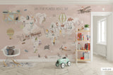 Children's room featuring a colorful world map wallpaper with illustrations of animals and vehicles. A wooden dresser and a canvas storage basket are visible in the room.