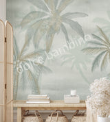 A section of wallpaper with a design of coconut trees and palm leaves in various shades of green, displayed in a room setting.