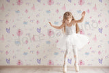 Repeated pattern style wallpaper featuring ballerinas and ballet-themed elements in pink and purple hues, with a house and garden decor setting.