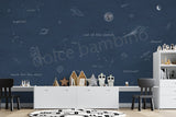 A space themed wallpaper featuring a deep blue celestial scene with illustrations of planets, a spaceship, and stars. 
