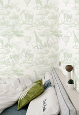 Bedroom with animal-themed wallpaper and decorative pillows.
