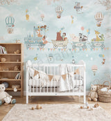 Children's room with crib, toys, and decorative wall mural featuring animals and vehicles.