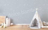 A children's playroom featuring a wall with a star-patterned wallpaper.
