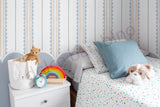Children's bedroom with striped pattern scalloped wallpaper, a bed, nightstand, and toys