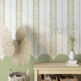  wall with striped pattern scalloped wallpaper, plants, and a wooden console table.