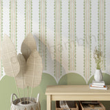  wall with striped pattern with scallops wallpaper,plants, and a wooden console table.