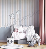 Children's room with striped pattern with scallops wallpaper, bed, toys, and decorative elements.