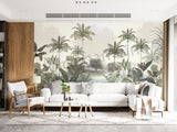 A room with walls covered in a vintage style wallpaper featuring lush trees and a serene landscape, with a modern armchair and bookshelf visible.